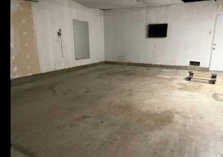 Before: an empty garage with a stained, unfinished concrete floor.