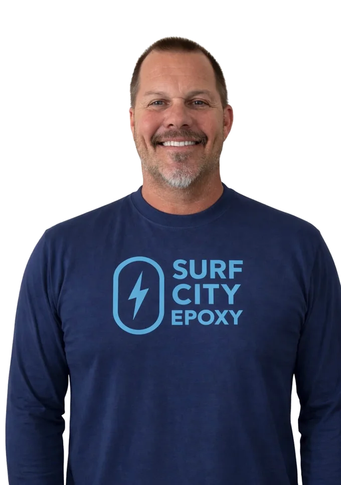 Sean Jensen, founder of Surf City Epoxy, in a navy company long-sleeve shirt.
